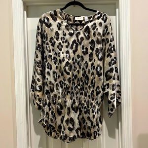 Silky wide armed top with elastic waist and draped peplum.